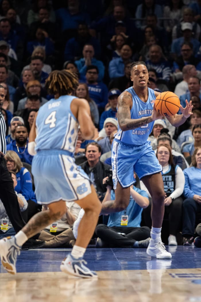 Dec 16, 2023; Atlanta, Georgia, USA; North Carolina Tar Heels forward Armando Bacot (5) passes the ball to North Carolina Tar Heels guard RJ Davis (4) in game against Kentucky Wildcats during the first half at State Farm Arena. Mandatory Credit: Jordan Godfree-USA TODAY Sports